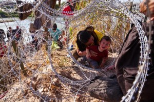 IMÁGENES: Niños migrantes pequeños gritan de dolor mientras se arrastran a través de alambre de púas en Eagle Pass